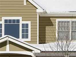 Green siding house in the winter