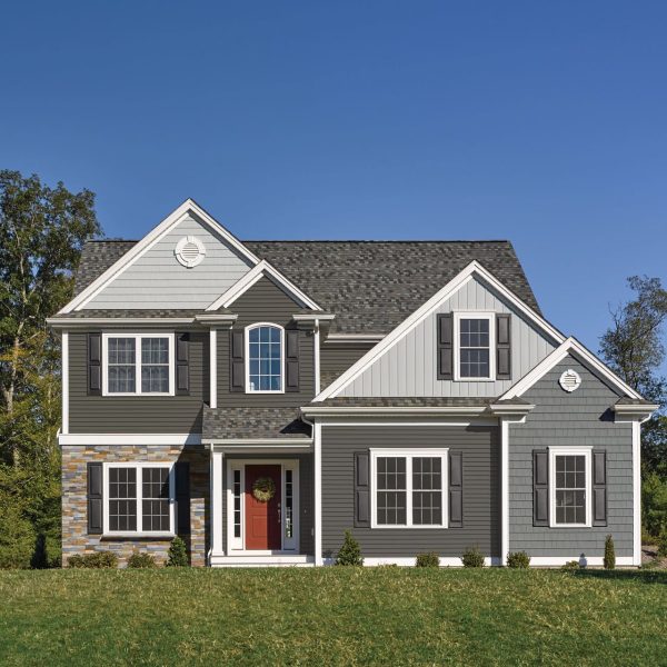 Brown siding with brick accent